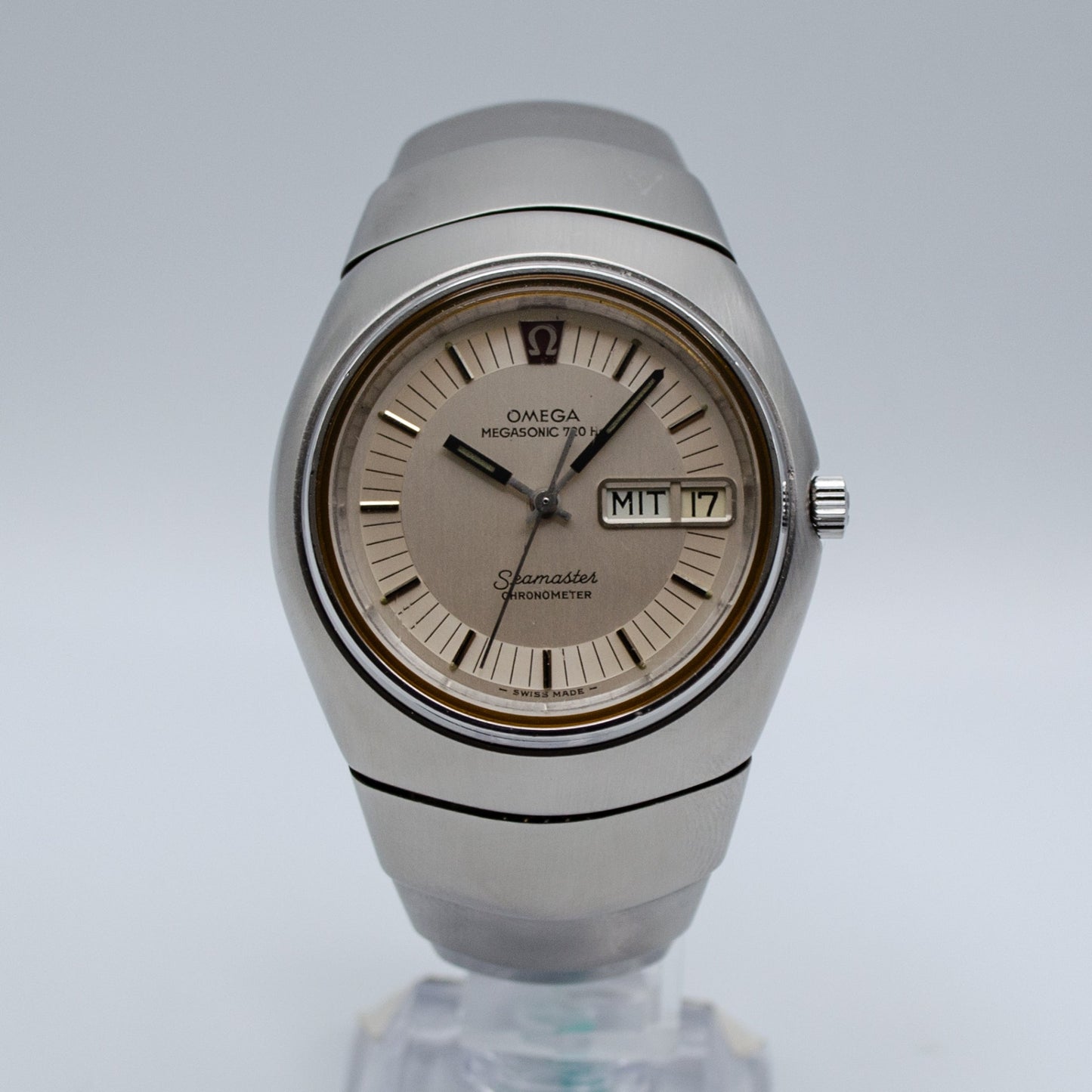 Silver Omega watch on a steel bracelet.