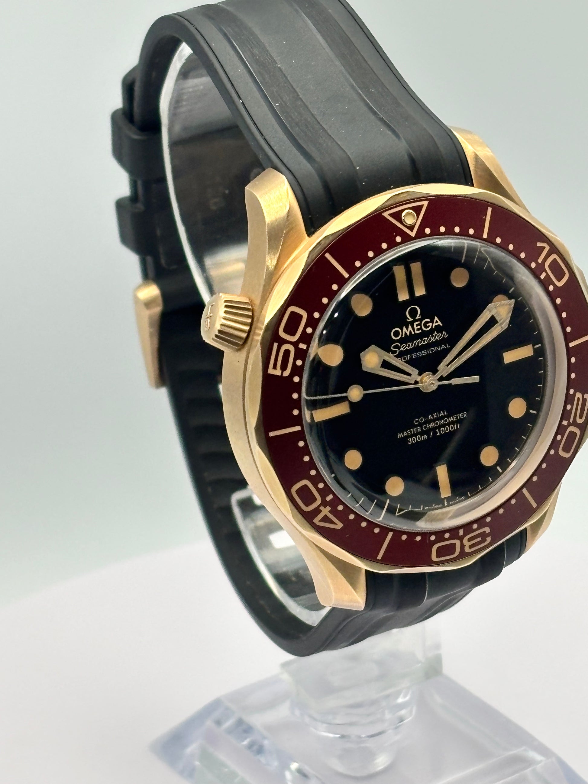 Omega Seamaster 300m Bronze-Gold watch on a rubber strap.