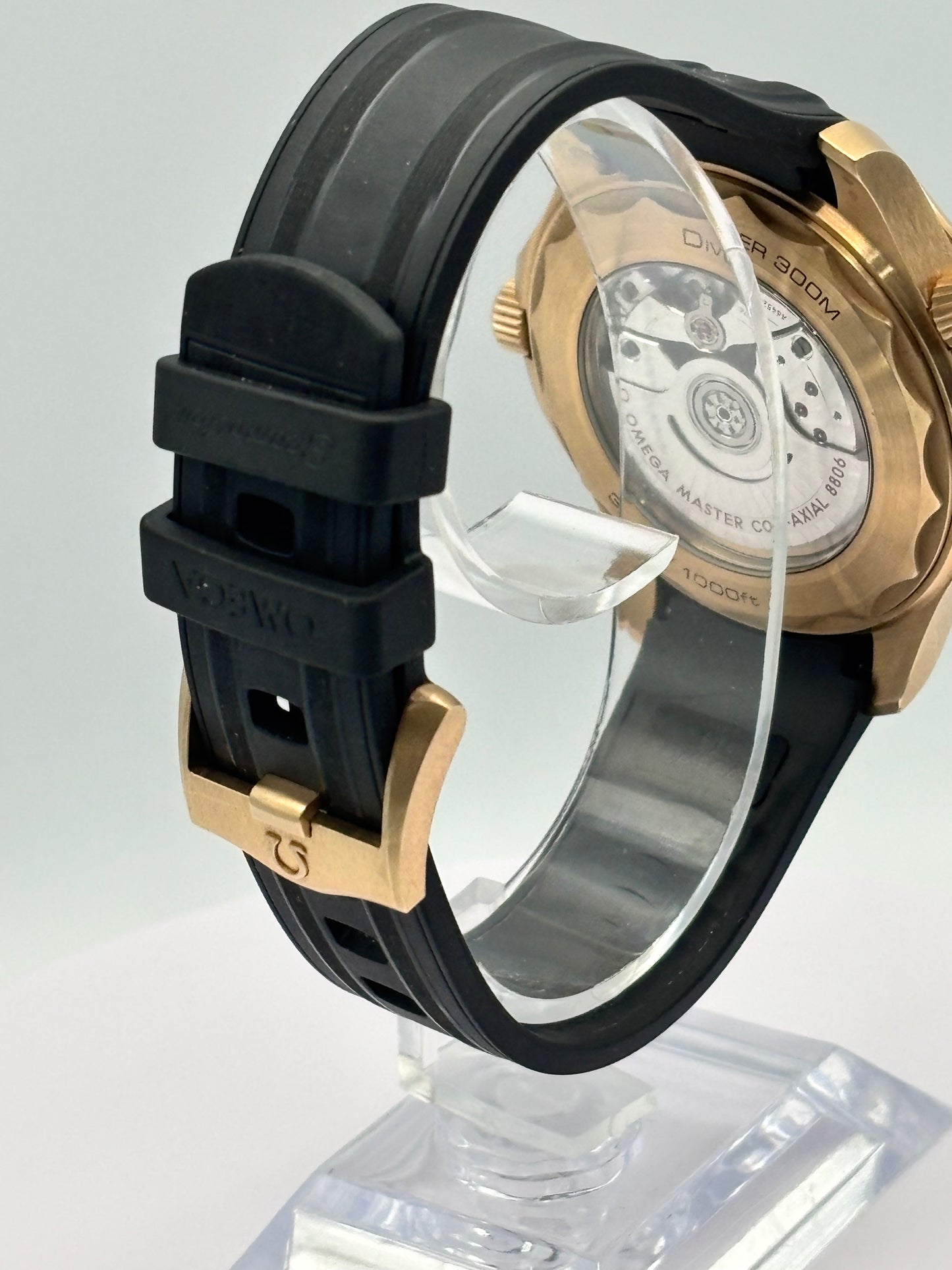 Omega Seamaster 300m Bronze-Gold watch on a rubber strap.