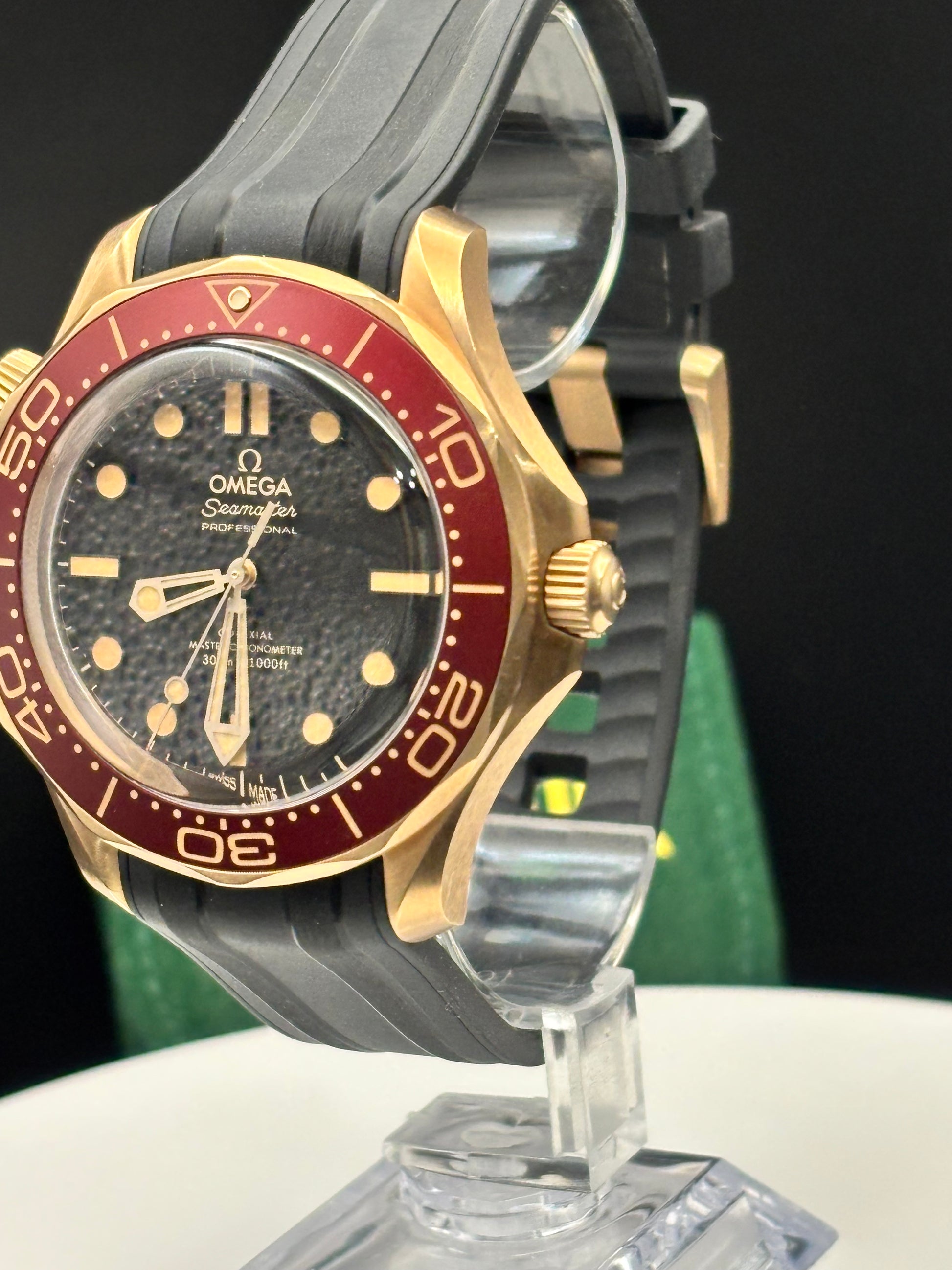 Omega Seamaster 300m Bronze-Gold watch on a rubber strap.