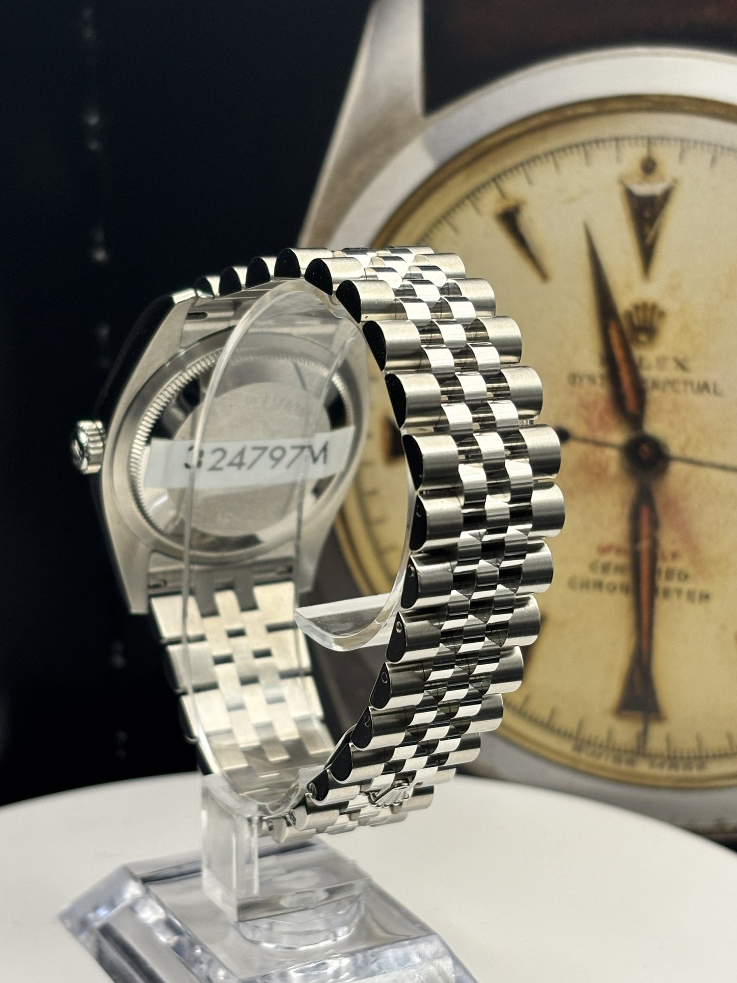 Silver watch on a stand with a blurred background