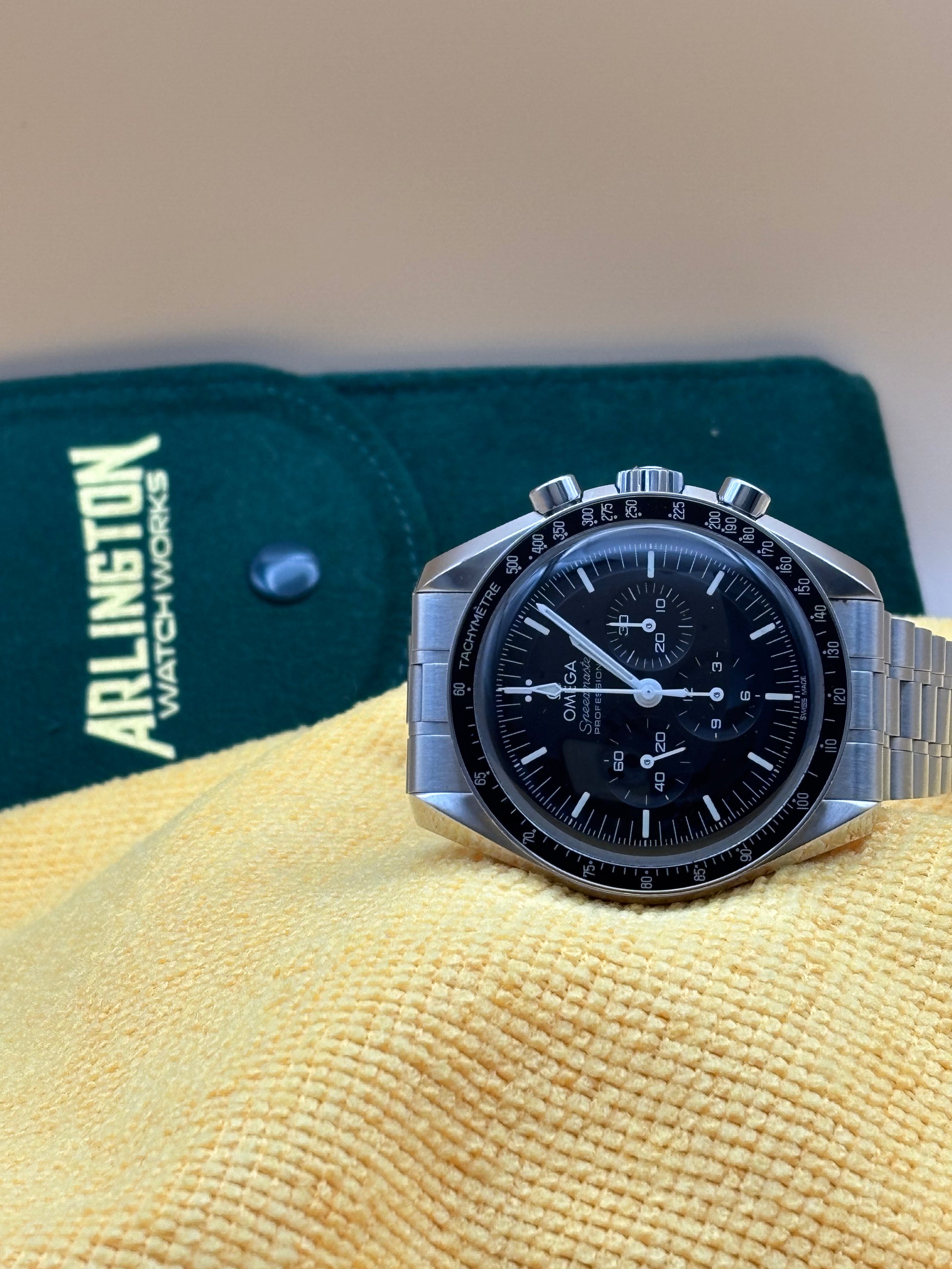 Omega Speedmaster watch on a steel bracelet.