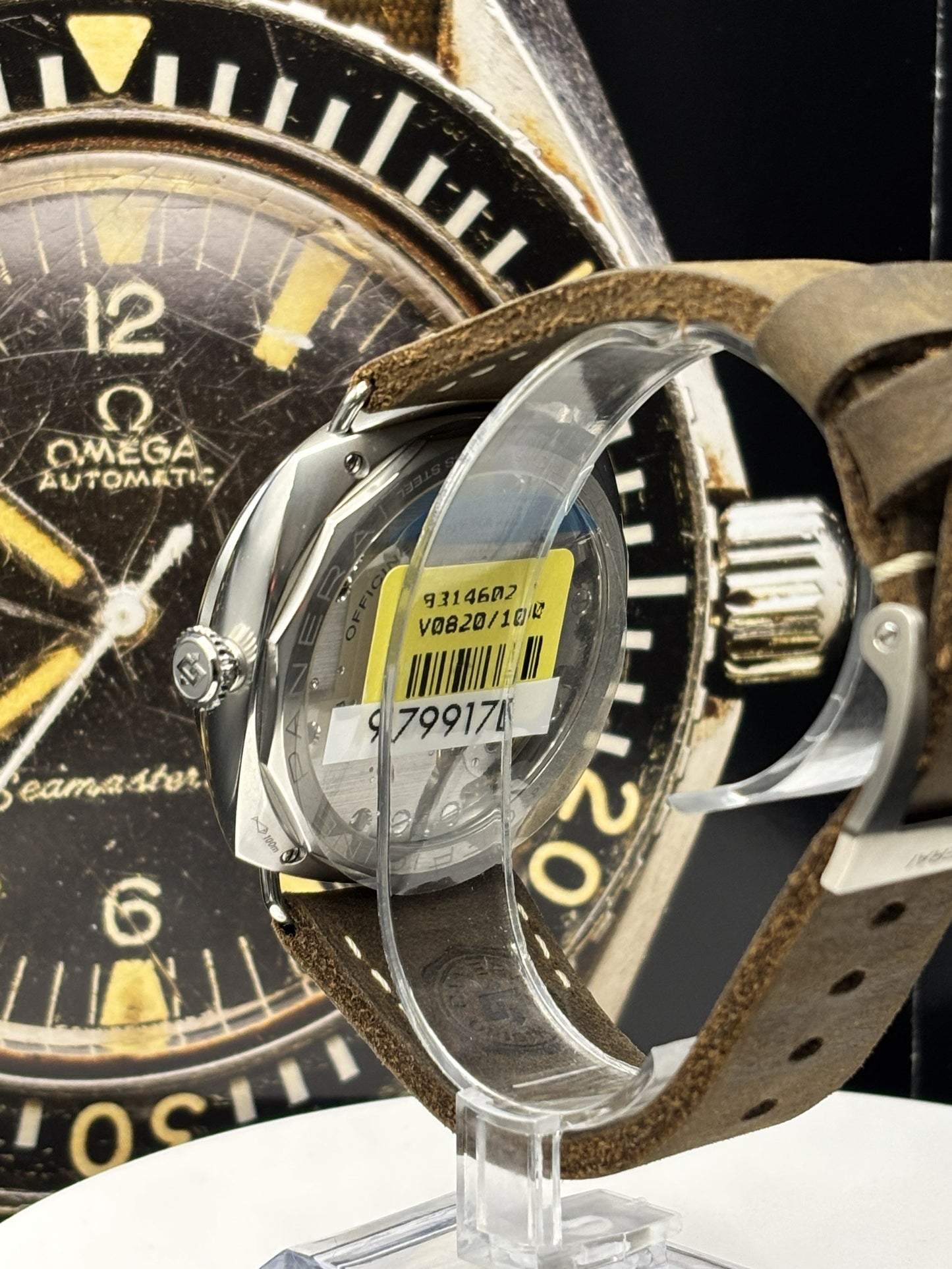 Close-up of a vintage Omega Seamaster watch with a brown leather strap.